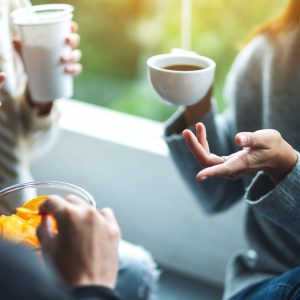 Rule5 Closeup image of friends talking, drinking and eating potato chips together
