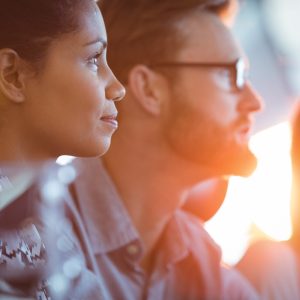 Rule3 Side view of concentrated businesswoman sitting in meeting room