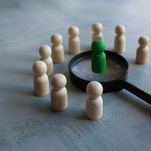 Rule4 Wooden dolls and magnifying glass. Job hiring, recruiting, finding the right candidate concept